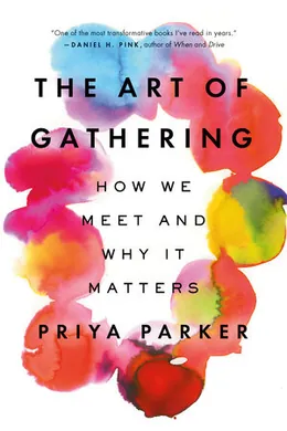 Front cover of The Art of Gathering by Priya Parker, with the title set inside a loose ring of overlapping watercolour blooms in pink, red and yellow.