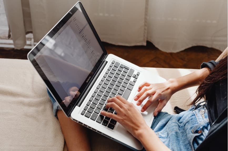 A person typing at a laptop.